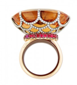 Taffin ring with oval-shaped imperial topaz, filigree basket in diamonds and rubies monuted in 18k yellow gold.