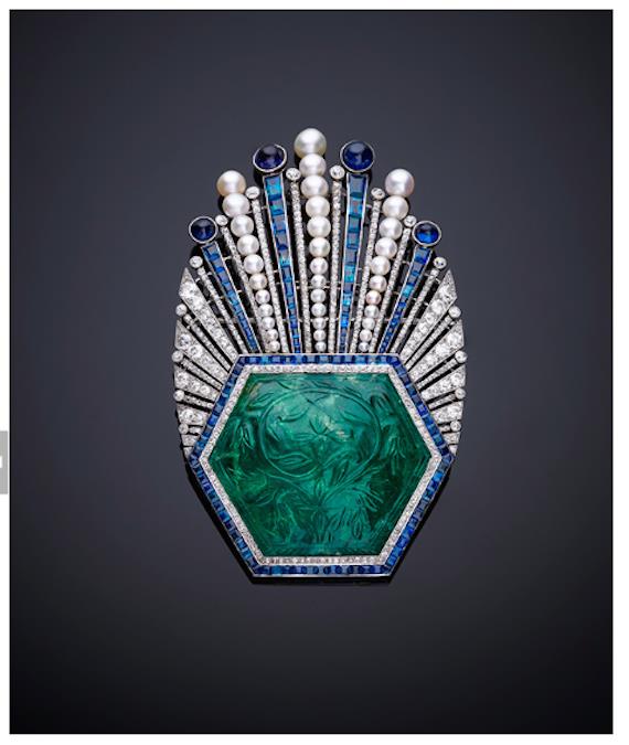 Ornament, Aigrette, Paul Iribe, Turban ornament with carved emerald of platinum, with a large hexagonal carved Indian emerald from 1850–1900, with millegrain-set diamonds and channel-set calibrécut sapphires. The Al Thani Collection 