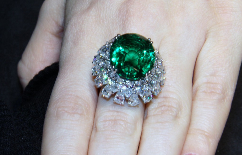 Gorgeous ring set with an impressive oval-shaped emerald and marquise cut diamonds, Picchiotti